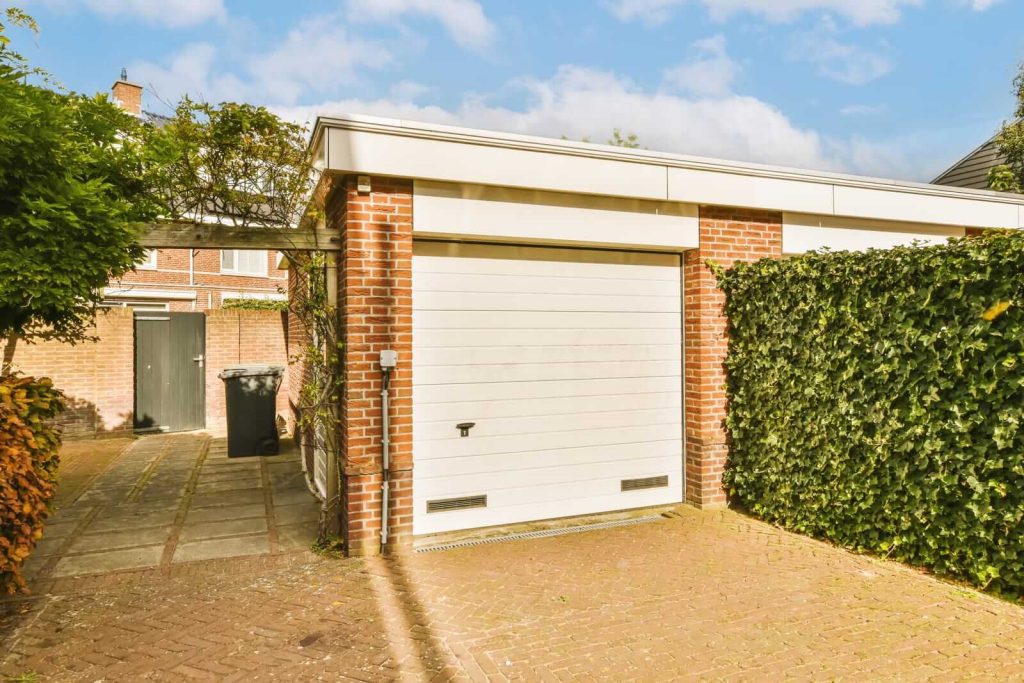 white-garage-door-in-front-of-a-brick-house